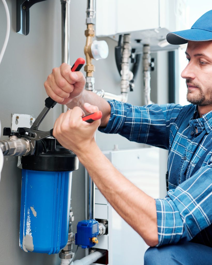 young-plumber-or-technician-installing-or-repairing-system-of-water-filtration.jpg